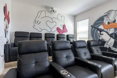 a room with black leather chairs and a wall with graffiti at BellaVida 8 bed Theme Rooms in Kissimmee