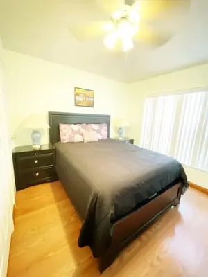 a bedroom with a bed and a ceiling fan at Indian Creek 4bd Pool in Orlando