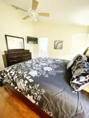 a bedroom with a bed and a ceiling fan at Indian Creek 4bd Pool in Orlando