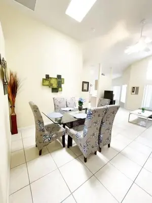 a living room with a dining table and chairs at Indian Creek 4bd Pool in Orlando