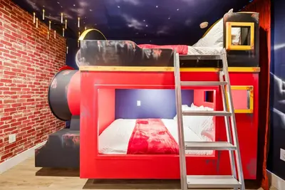 a kids room with a bunk bed and a ladder at NEW Cozy 2 Bedrooms2Baths At Encantada in Kissimmee