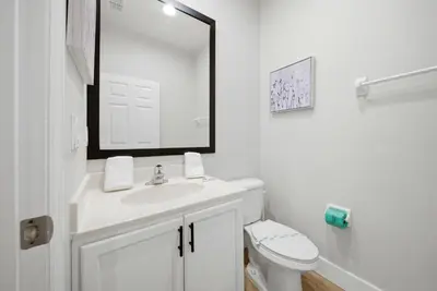a white bathroom with a sink and a toilet at NEW Cozy 2 Bedrooms2Baths At Encantada in Kissimmee