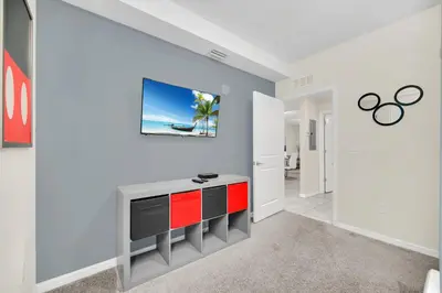 a living room with a tv on a wall at Ev4721C304 - Sunset Nest in Kissimmee