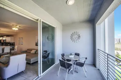 a room with a balcony with a table and chairs at Ev4721C304 - Sunset Nest in Kissimmee