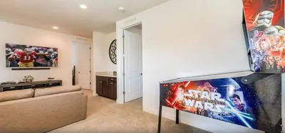 a living room with a star wars movie on the wall at Ultimate Mansion-9Bed-PoolSpaGame in Orlando