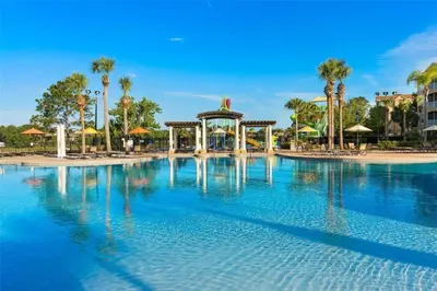 a large swimming pool with a gazebo and palm trees at Windsor Hills Marvel Themed Home with Private Pool in Orlando