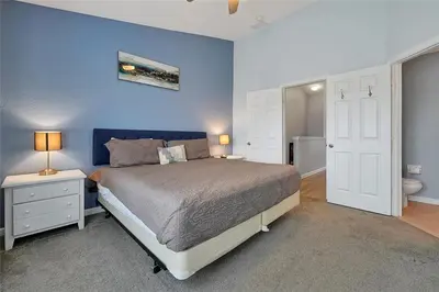 a bedroom with a bed and a blue wall at Windsor Hills Marvel Themed Home with Private Pool in Orlando