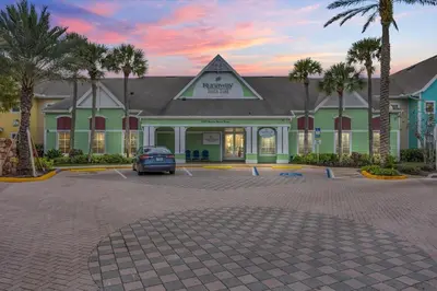 a car parked in a parking lot in front of a hotel at Family Resort Condo Disney 5 miles in Kissimmee