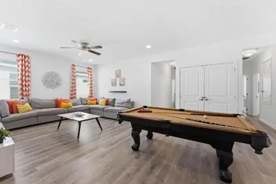 a living room with a pool table in it at Chic Modern Escape 12BR Pool and Game Room in Kissimmee