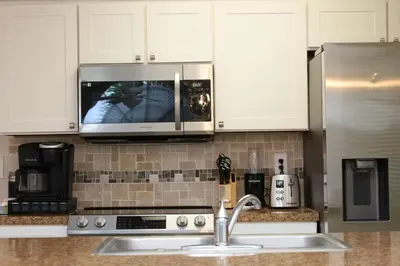 a kitchen with a sink and a microwave at 
