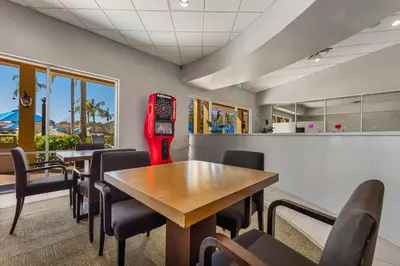 a restaurant with tables and chairs and a red soda machine at 3179 Yellow Lantana Lane in Kissimmee