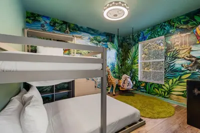 a childs bedroom with a dinosaur themed wall at 3179 Yellow Lantana Lane in Kissimmee