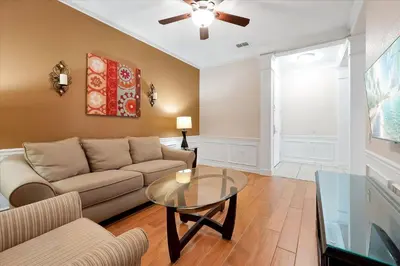 a living room with a couch and a glass table at Beautiful Condo, Near Epic Universe and OCCC-2018 by Vista Cay Resort in Orlando