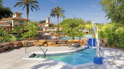 a swimming pool with a water slide in a resort at Orange Lake Vacation Time in Orlando