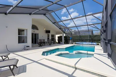 a swimming pool in a house with a glass ceiling at Private Pool with spa and Game Room Near Disney in Kissimmee