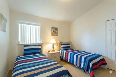 a bedroom with two beds and a window at Private Pool with spa and Game Room Near Disney in Kissimmee
