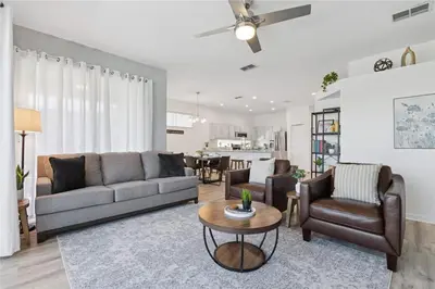 a living room with a couch and chairs and a table at Disney World, Universal Epic Waterfront Modern Home - Private Pool And Game Room in Kissimmee