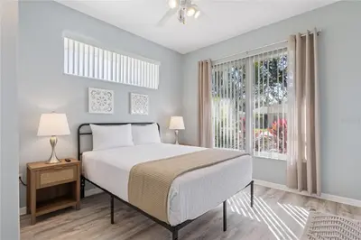 a bedroom with a bed and a window at Disney World, Universal Epic Waterfront Modern Home - Private Pool And Game Room in Kissimmee