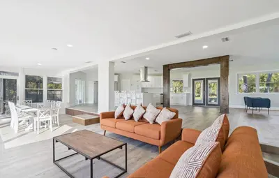 a living room with a couch and a table at Lakefront Luxury w Private Dock Sunrises in Orlando