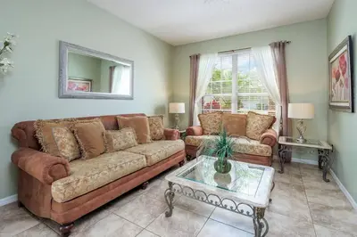 a living room with a couch and a table at Luxury 7BR w Pool Lake View at Berkley in Kissimmee