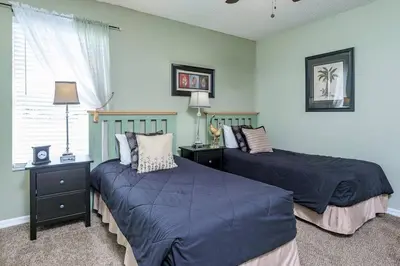 a bedroom with two beds and a window at Luxury 7BR w Pool Lake View at Berkley in Kissimmee