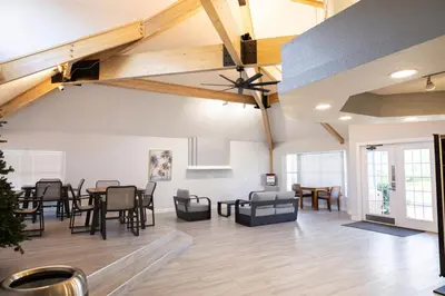 an open living room with wooden ceilings and tables and chairs at 3BR Disney Home with Pool , Arcade and Hot Tub in Kissimmee