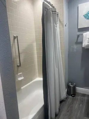 a bathroom with a shower and a white tub at Condo Epic Universal Disney Free Parking in Orlando