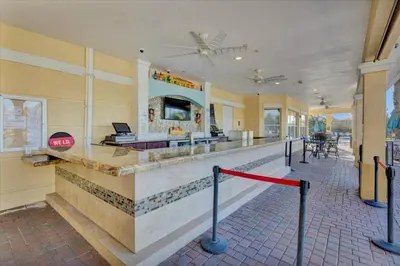 a lobby of a resort with a bar at Upstay Great 3BR Condo w Scenic Views & Patio in Orlando