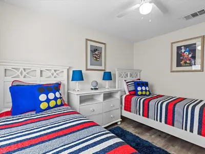 a bedroom with two beds and blue lamps at 4bd Villa Near Epic Universe and Disney with private Pool townhouse in Kissimmee