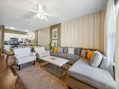 a living room with a couch and a table at Elegant Townhome at West Lucaya in Kissimmee