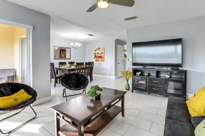 a living room with a couch and a tv at 5 Mi to WDW! Spacious Resort Escape with Pool Access in Kissimmee