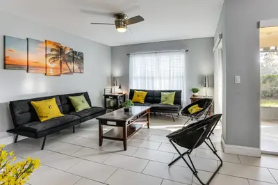 a living room with a couch and a table at 5 Mi to WDW! Spacious Resort Escape with Pool Access in Kissimmee