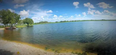 a view of a large lake on a sunny day at Charming Lakefront Cottage Near Disney in Orlando