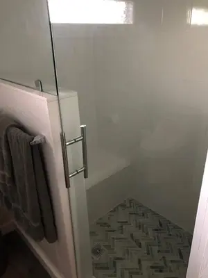 a bathroom with a shower with a glass door at Charming Lakefront Cottage Near Disney in Orlando
