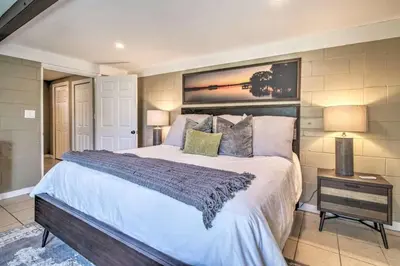 a bedroom with a large bed in a room at Charming Lakefront Apt Near Disney in Orlando