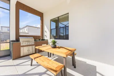 a kitchen with a wooden table and a bench at Paradiso’s Luxurious New Home w 15 Ensuites in Orlando