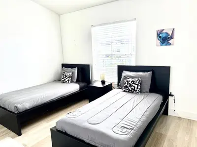 a bedroom with two beds and a window at Affordable Suite Near Disney World, Universal Studios & SeaWorld in Orlando