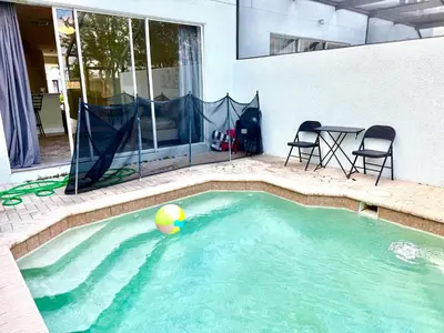 a swimming pool with a beach ball in the water at Affordable Suite Near Disney World, Universal Studios & SeaWorld in Orlando