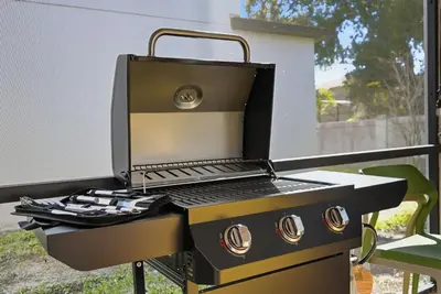 a grill with a laptop on top of it at Casita Coco - Private Pool - Foosball - BBQ in Kissimmee