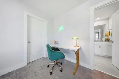a office with a desk and a green chair at Casita Coco - Private Pool - Foosball - BBQ in Kissimmee