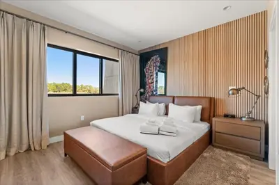 a bedroom with a bed and a large window at 5565Torino in Kissimmee