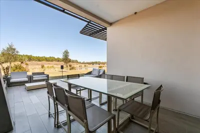 a dining room with a table and chairs on a patio at 5565Torino in Kissimmee
