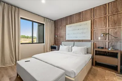 a bedroom with a large white bed and a window at 5565Torino in Kissimmee