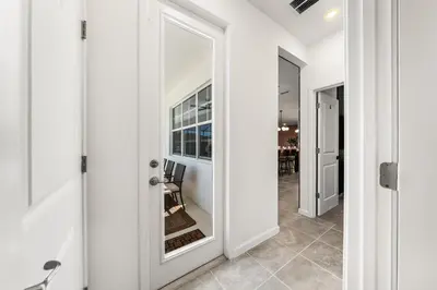 a door leading to a dining room with a mirror at Resort-Style Living w Private Pool & Amenities in Kissimmee