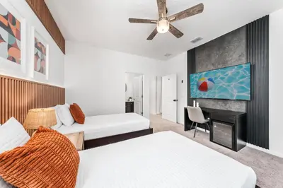 a living room with two beds and a fireplace at Resort-Style Living w Private Pool & Amenities in Kissimmee