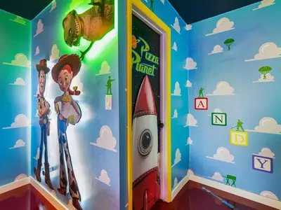 a room with a rocket painted on the wall at Toy Story Magic Studio Close to Disney in Kissimmee