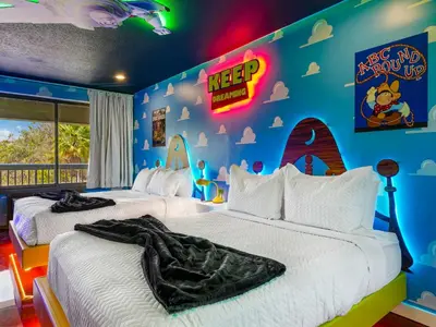 a childrens bedroom with two beds and akeep sign on the wall at Toy Story Magic Studio Close to Disney in Kissimmee