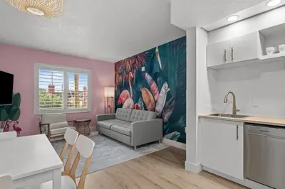 a kitchen and living room with a couch and a table at Florida vibe suite near Epic Universe & Universal in Orlando