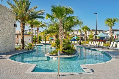 a swimming pool with palm trees in a resort at 2026 NEW 12Bedrooms12Bathroom At Paradiso Grande in Orlando