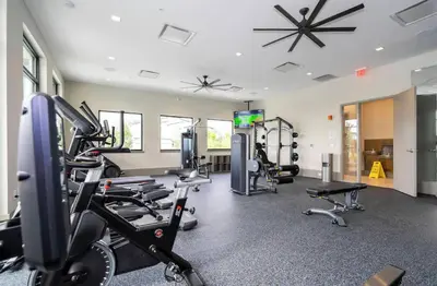 a gym with treadmills and machines in a room at 2026 NEW 12Bedrooms12Bathroom At Paradiso Grande in Orlando